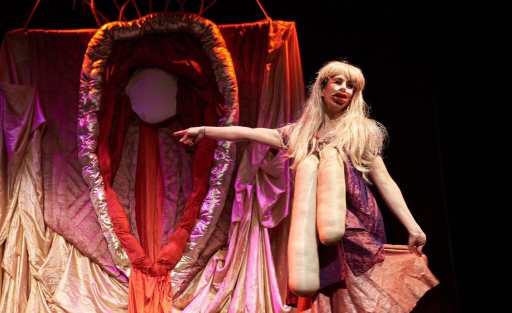 Image of China Blue Fish and Deborah Antoinette pointing to a vulva in their menstrual taboo busting show.